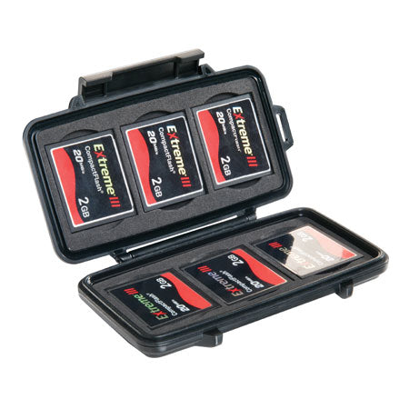 A black Pelican 0940 compact flash memory-card protector case open, displaying several memory cards stored in the precut foam.