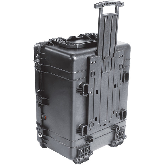 Load image into Gallery viewer, A black Pelican 1630 Transport Case standing up with the top handle pulled out, showing how the case can be moved on its wheels.
