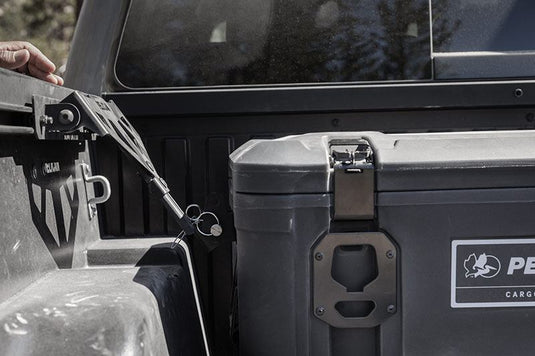 A black Pelican Cargo BX135 case that is mounted to the interior of a truck bed.