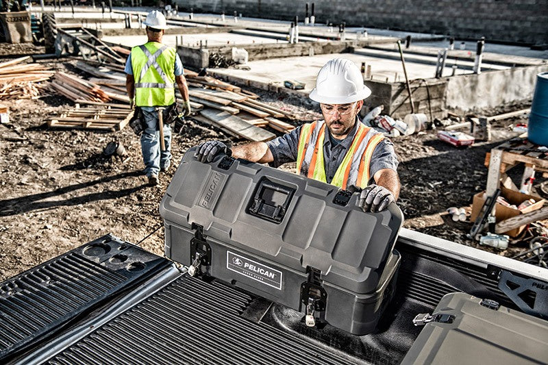 Load image into Gallery viewer, A construction worker is opening a black BX55S case in the bed of a truck. He is at a construction site.
